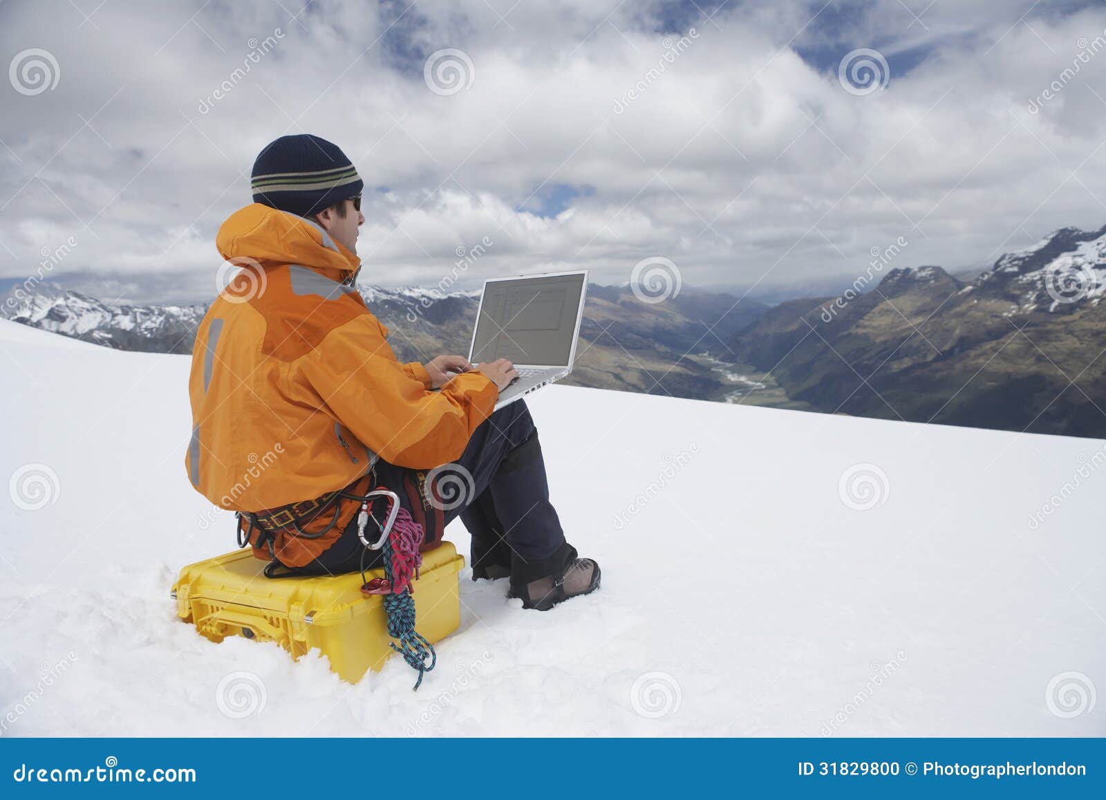 hiker-using-laptop-snowy-mountain-landscape-view-male-31829800.jpg
